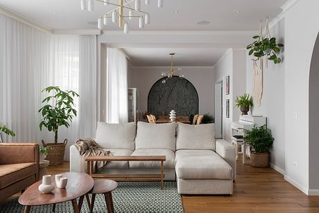 Elegant living room with modern furniture and green accents.