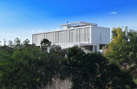 Modern white house with flat roof amidst greenery.