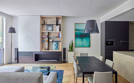 Modern living room with sleek furniture and abstract art.