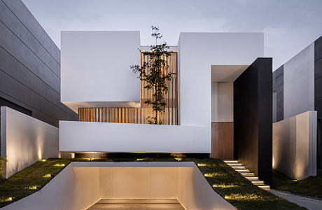 Modern minimalist architecture with clean lines, illuminated at dusk.