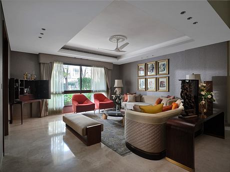 Elegant living room with neutral tones, plush seating, and wall art.