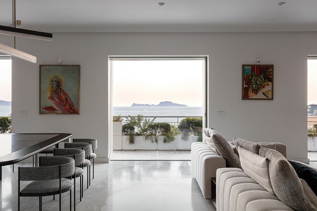 Sleek interior with ocean view, artwork, and neutral tones.