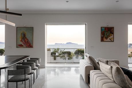 Sleek interior with ocean view, artwork, and neutral tones.