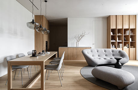 Modern dining and living room with wood furniture and neutral tones.