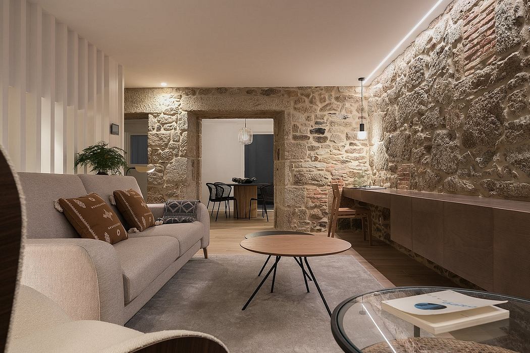 Contemporary living room with exposed stone walls and warm lighting.