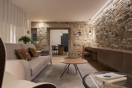 Contemporary living room with exposed stone walls and warm lighting.