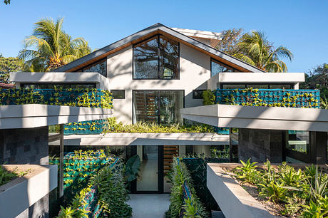 Modern home with geometric design and green plant balconies.