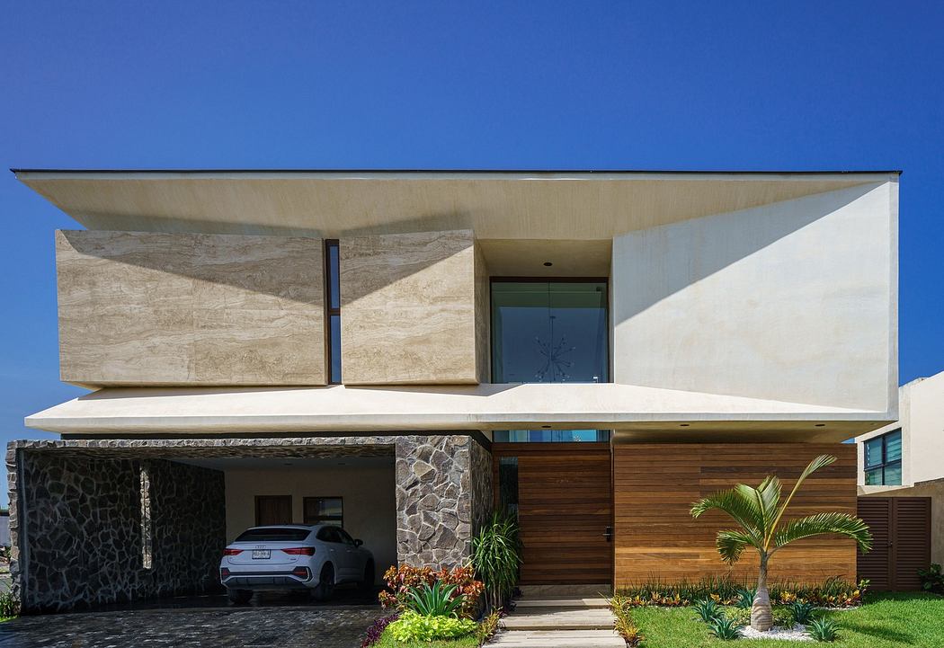 Contemporary house with geometric facade and carport.