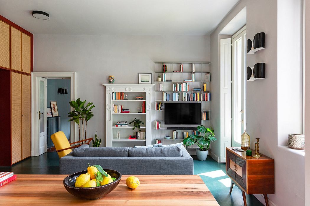 Modern living room with sofa, bookshelves, and decorative plants.