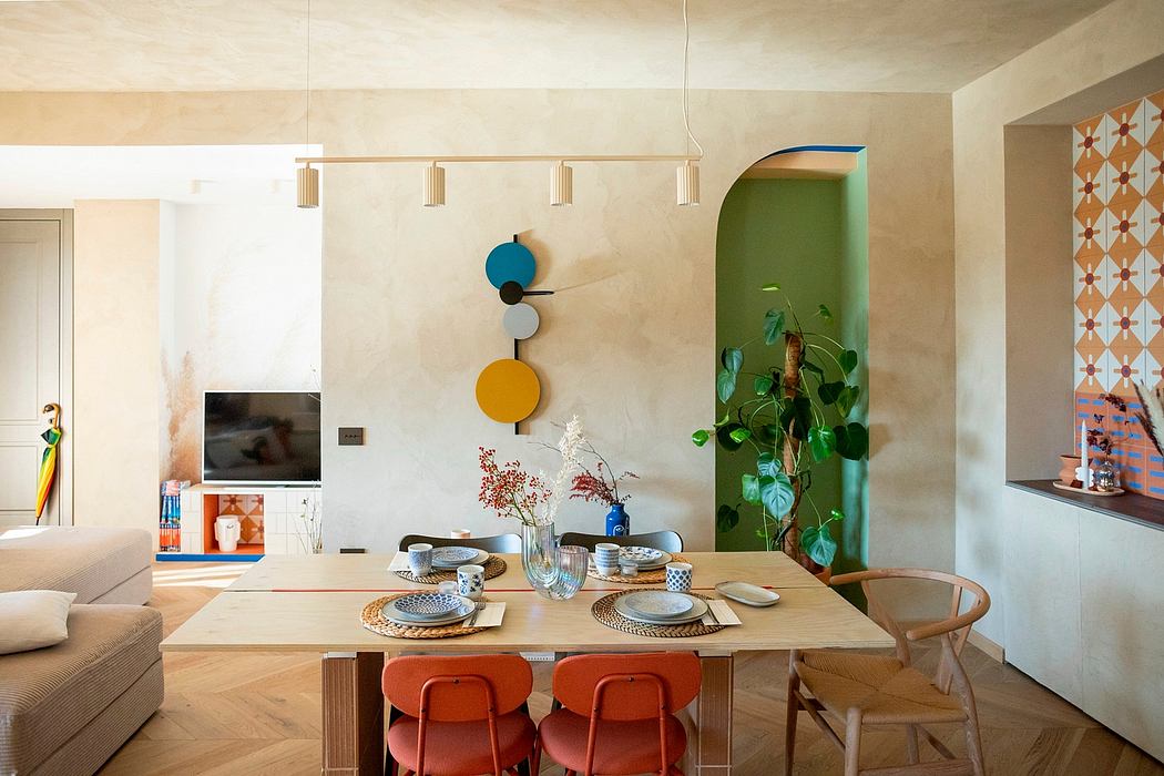 Modern dining room with wooden table, orange chairs, and colorful decor.