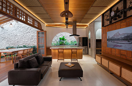 Contemporary living space with wooden accents and tropical elements.