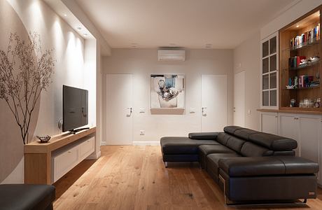 Contemporary living room with sleek furniture and warm lighting.