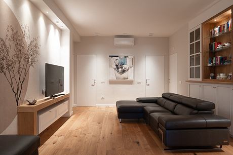 Contemporary living room with sleek furniture and warm lighting.