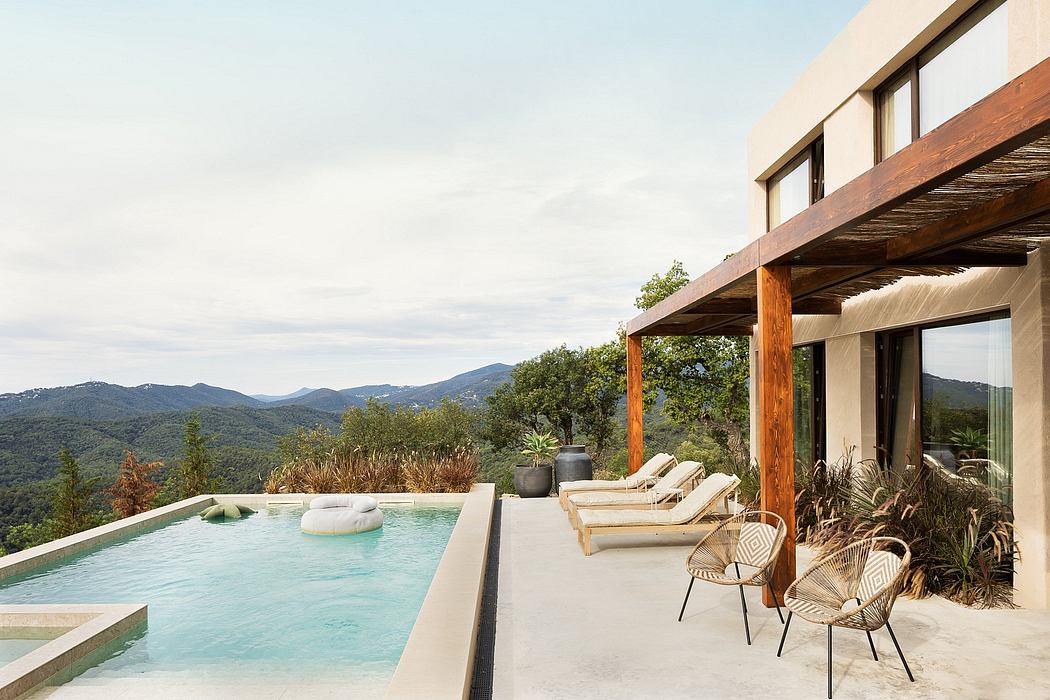 Modern house with infinity pool overlooking mountains.