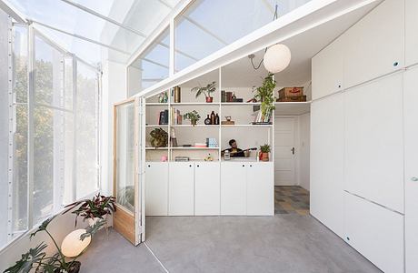 Bright, airy kitchen with glass walls and minimalist design.