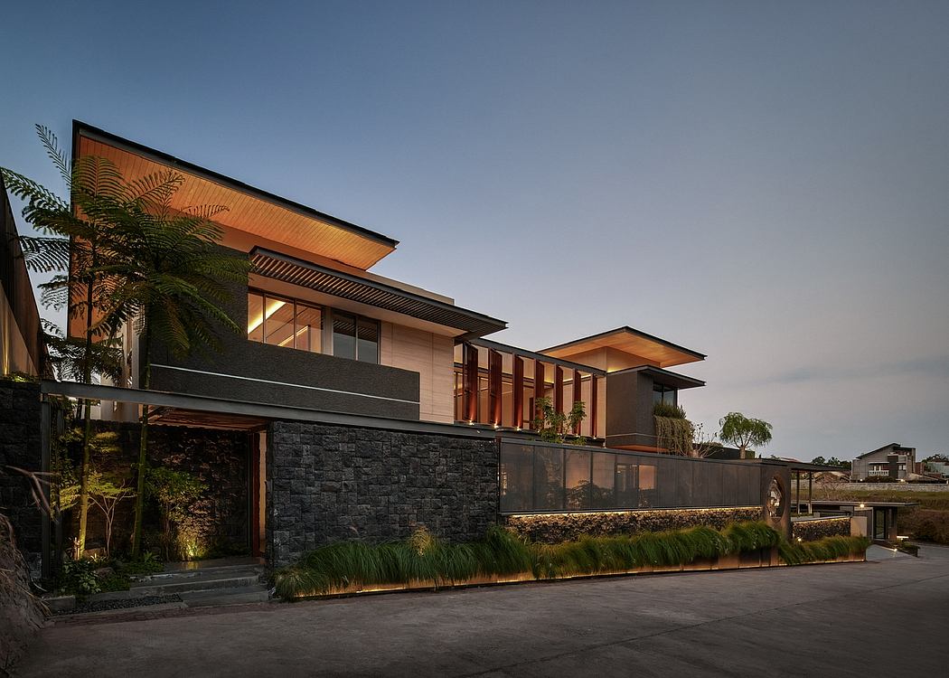 Contemporary house with geometric lines and warm lighting at dusk.