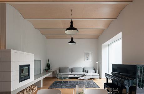 Contemporary living room with a minimalist design, neutral tones, and a piano.