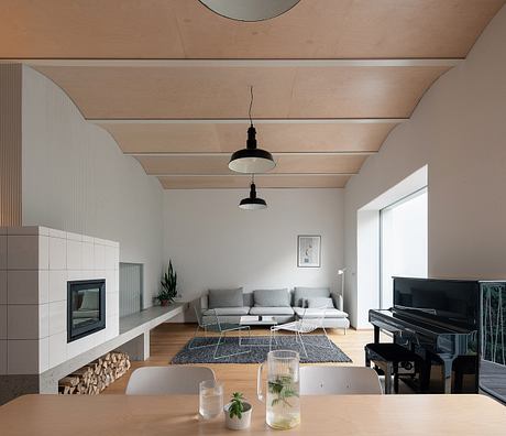 Contemporary living room with a minimalist design, neutral tones, and a piano.