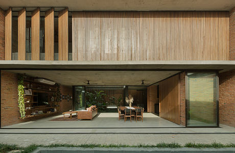 Modern house with open-plan living area, wooden slats, and concrete exterior.