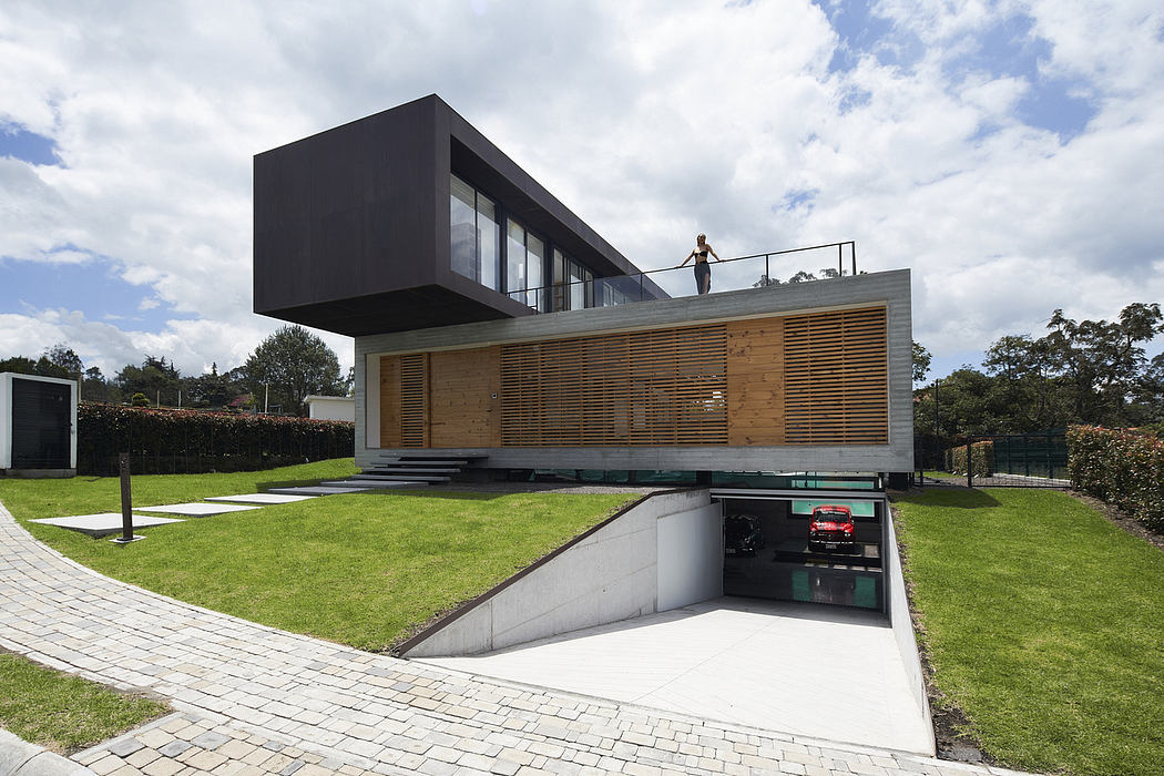 Modern two-story house with cantilevered upper floor and lawn.
