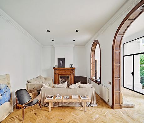 Elegant living room with archway, fireplace, and modern furniture.