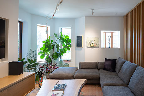 Contemporary living room with neutral tones and indoor plants.