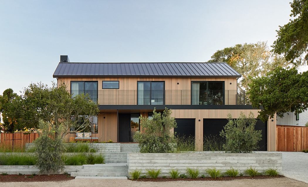Modern two-story house with a metal roof and wooden siding.