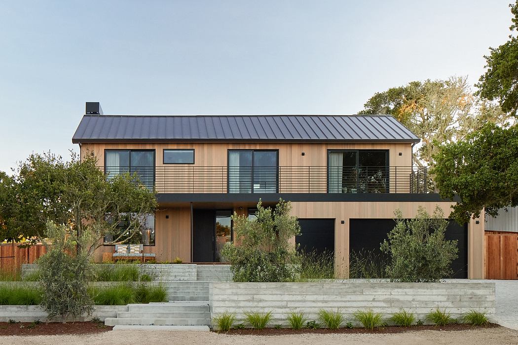 Modern two-story house with a metal roof and wooden siding.
