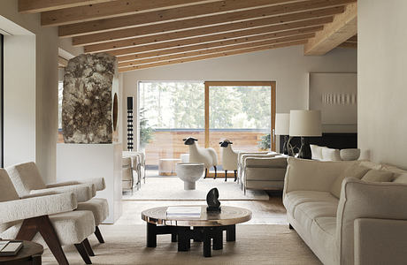 Modern living room with neutral tones, wooden beams, and elegant furniture.