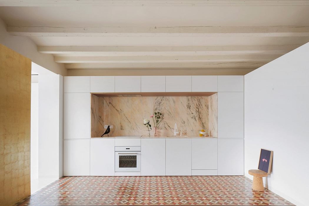 Minimalist kitchen with marble backsplash and patterned tile floor.
