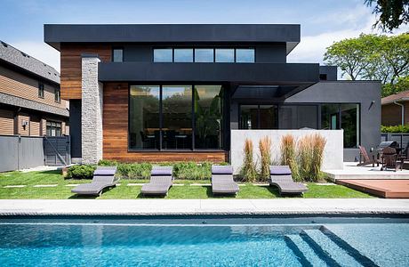 Contemporary house with pool and wooden accents.