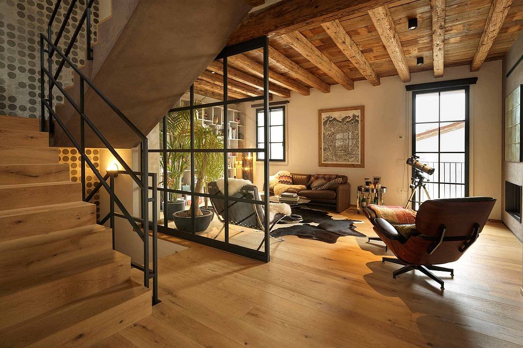 Rustic-chic living space with exposed beams and a sleek staircase.