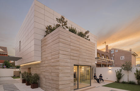 Contemporary two-story house with pool at dusk.