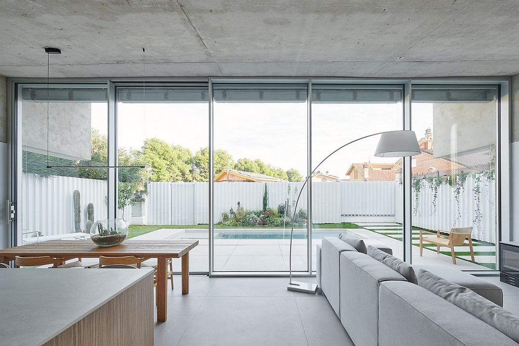 Modern living room with large windows overlooking a garden.