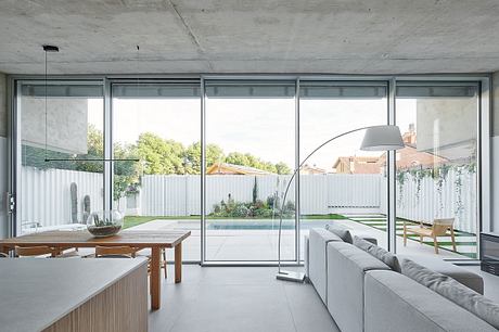 Modern living room with large windows overlooking a garden.