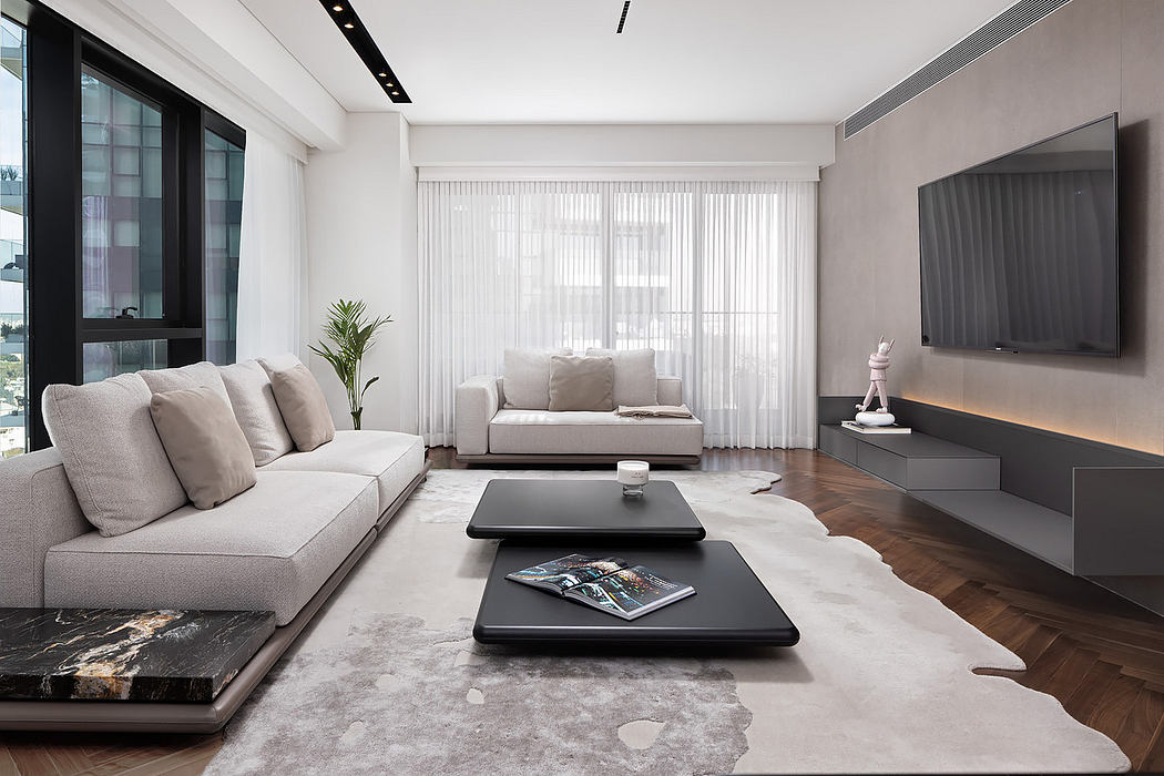 Modern living room with sleek furniture and neutral tones.