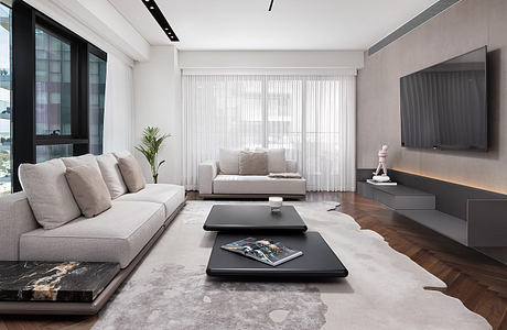 Modern living room with sleek furniture and neutral tones.