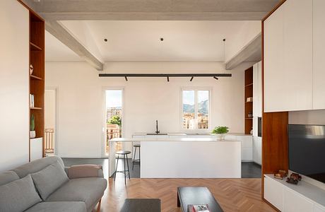 Contemporary living space with minimalist design and exposed ceiling beams.