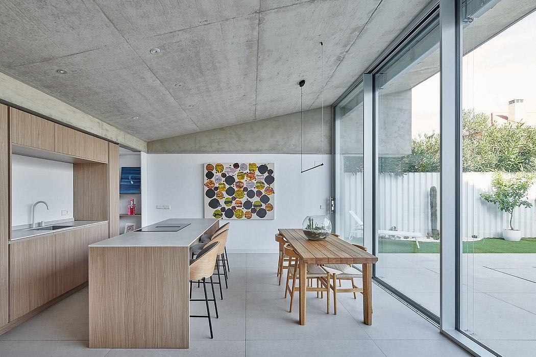 Minimalist kitchen with concrete ceiling, wooden furniture, and floor-to-ceiling windows