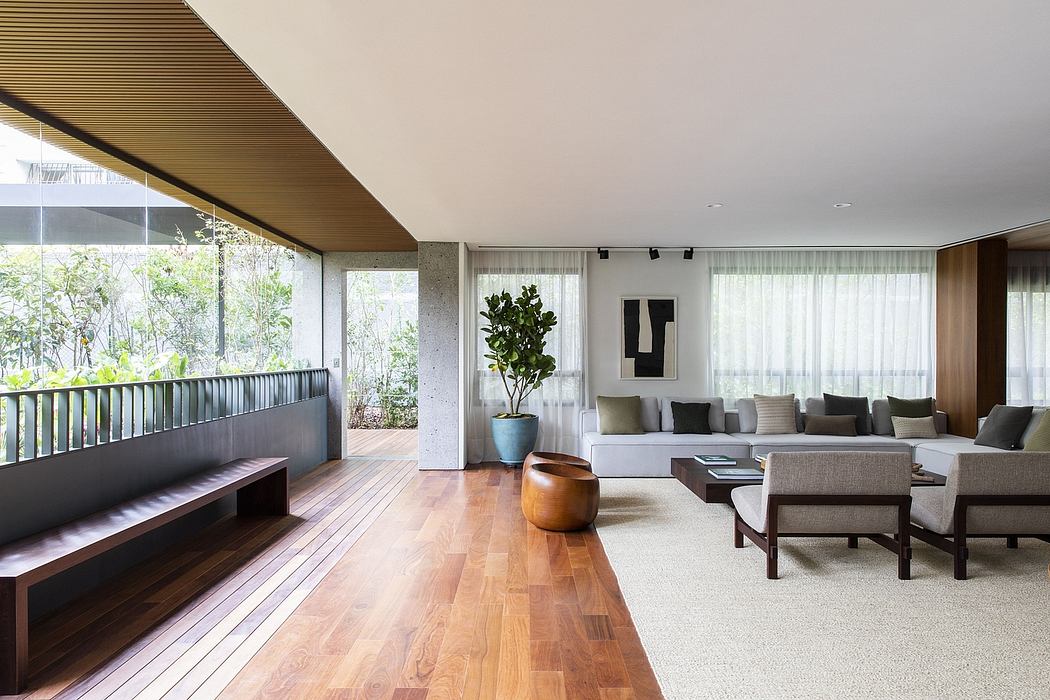 Contemporary living room with wooden floors and large windows.
