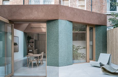 Modern home extension with glass walls and textured columns.