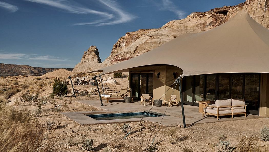 Luxury tent-like structure with a plunge pool in a desert landscape.