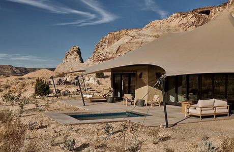 Luxury tent-like structure with a plunge pool in a desert landscape.