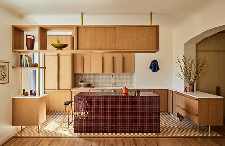 Modern kitchen interior with wooden cabinetry and terracotta accents.