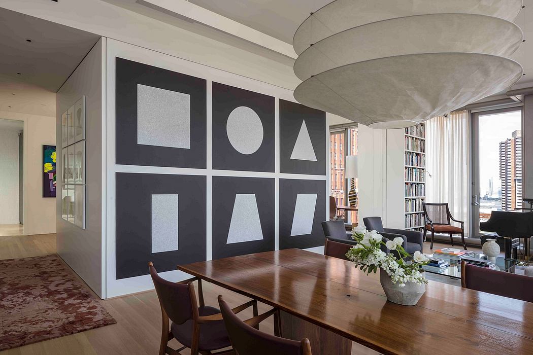Contemporary dining room with geometric wall art and circular pendant light.