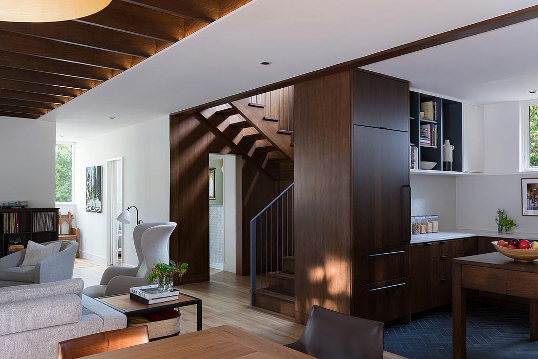 Contemporary living space with elegant wooden staircase and furnishings.