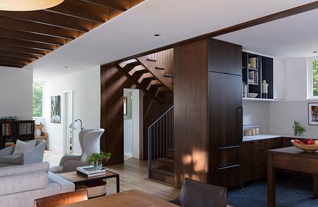 Contemporary living space with elegant wooden staircase and furnishings.