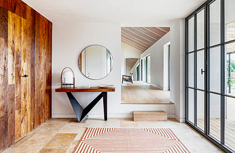 Modern minimalist interior with wooden accents and geometric patterns.