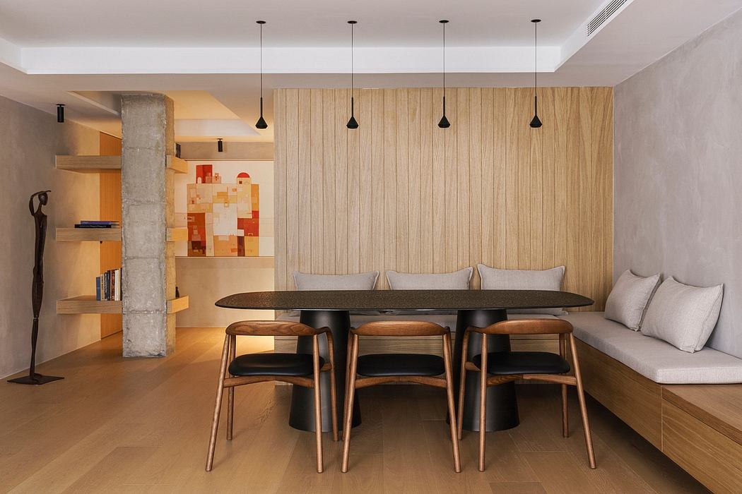 Modern dining room with wooden table, chairs, pendant lights, and art piece.