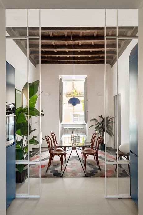 Modern interior with glass walls, exposed wooden beams, and eclectic furnishings.